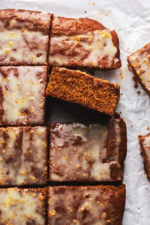 pieces of gingerbread cake with orange glaze on parchment paper