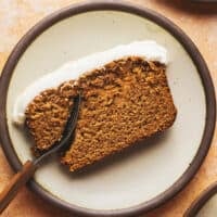 single slice of gingerbread loaf with fork on plate