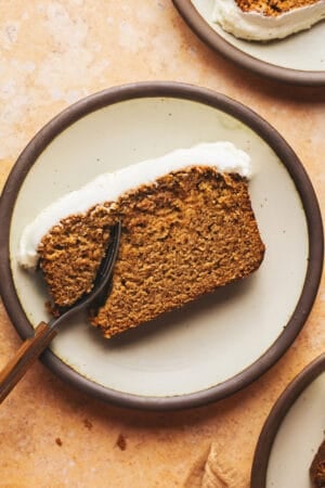 single slice of gingerbread loaf with fork on plate