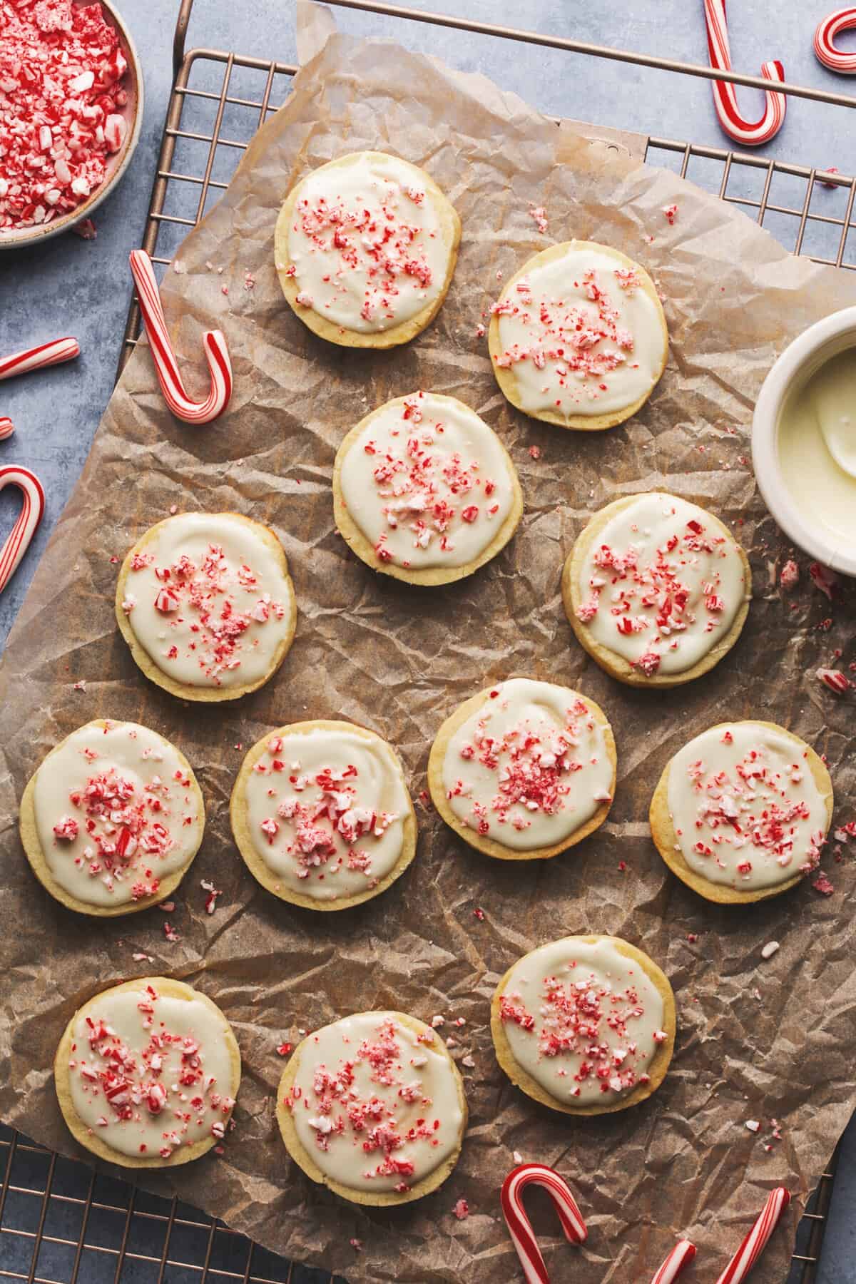 iced peppermint cookies on tabletop with candy canes