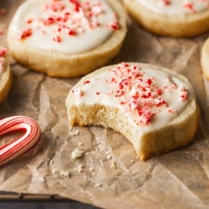 up close peppermint cookie with bite out of the side resting on parchment paper