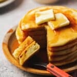 pancakes on plate with fork and some bites cut out