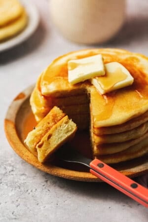 pancakes on plate with fork and some bites cut out