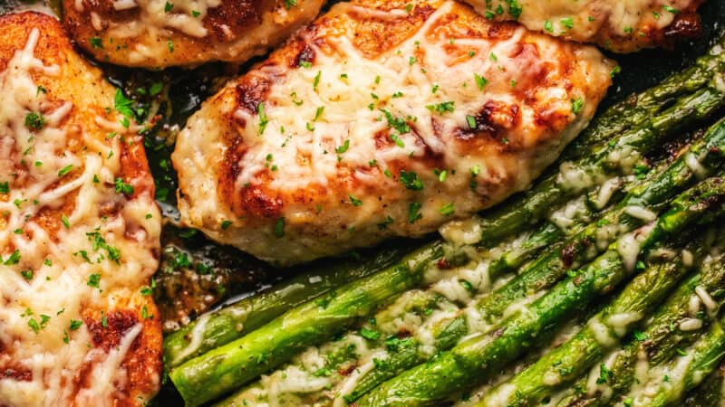 seasoned chicken and asparagus topped with melted parmesan cheese