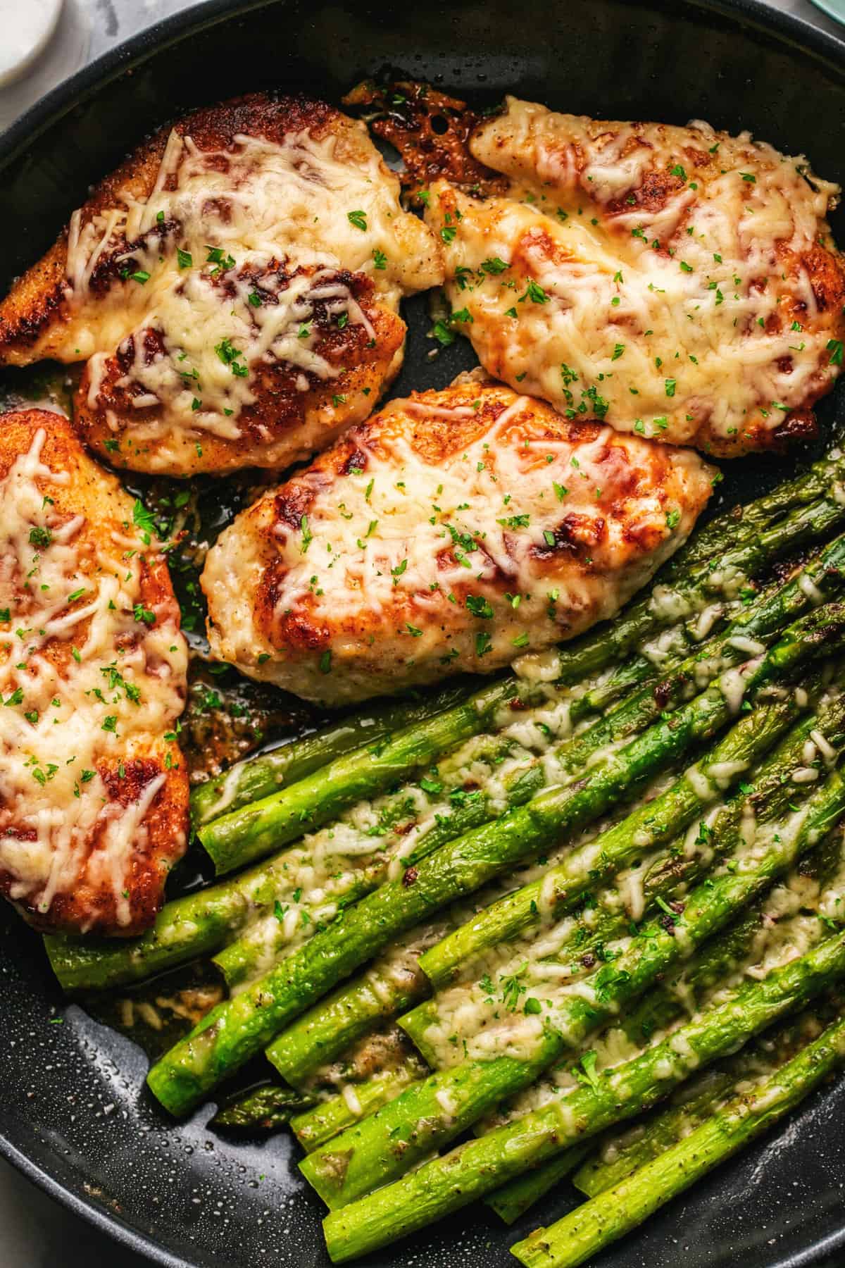 seasoned chicken and asparagus topped with melted parmesan cheese