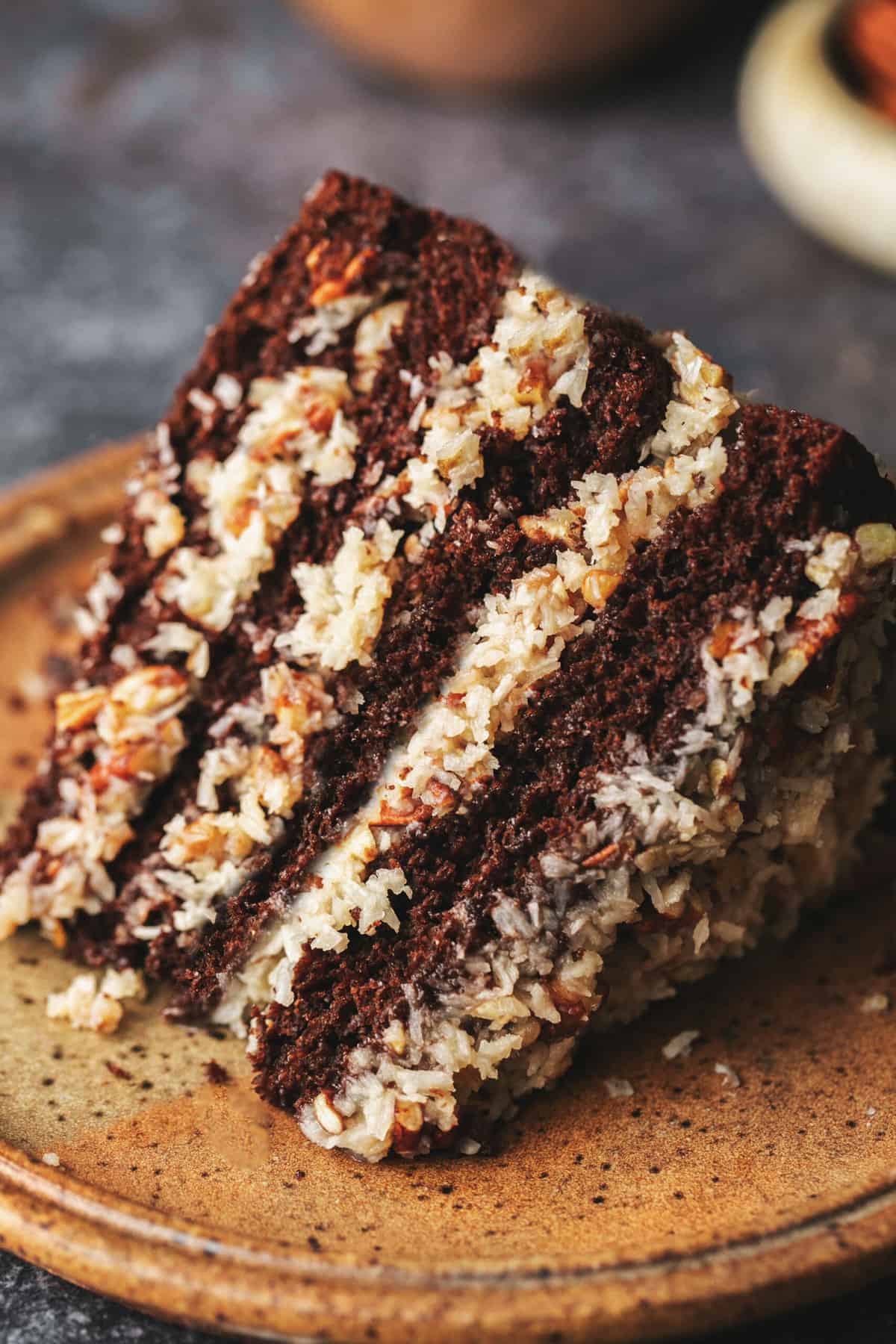 single slice of cake with coconut frosting on plate