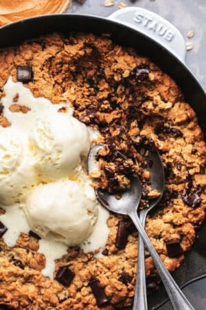 skillet pizookie with two spoons and ice cream