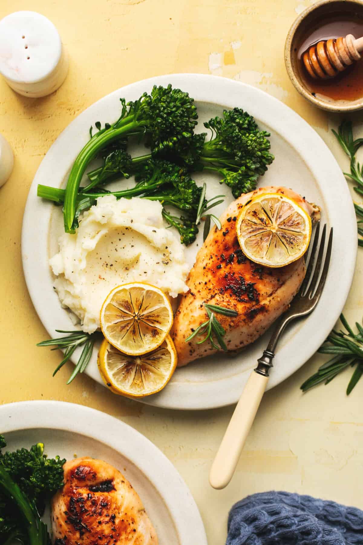 plate with chicken breast, broccolini, and mashed potatoes