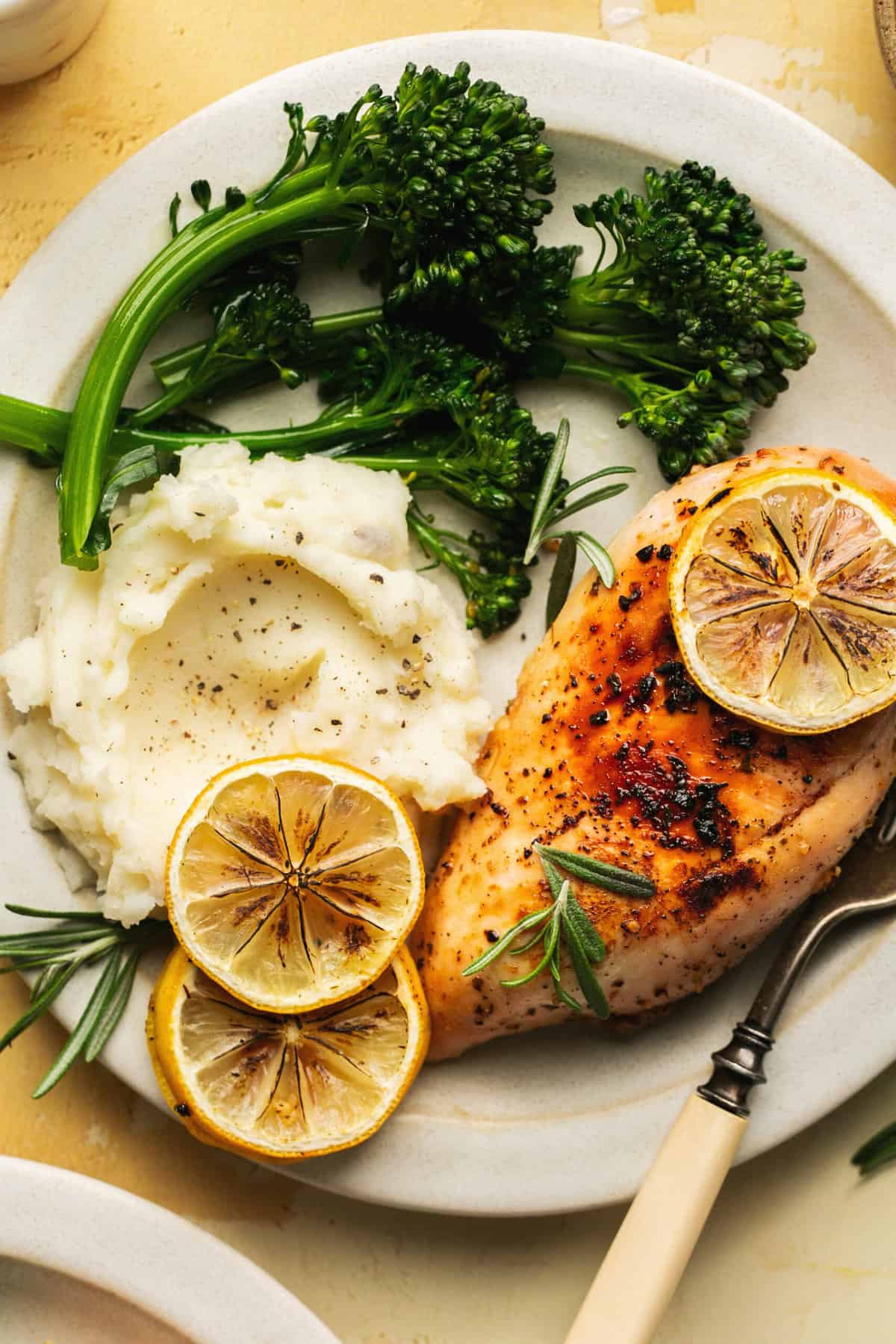 plate with chicken breast, broccolini, and mashed potatoes