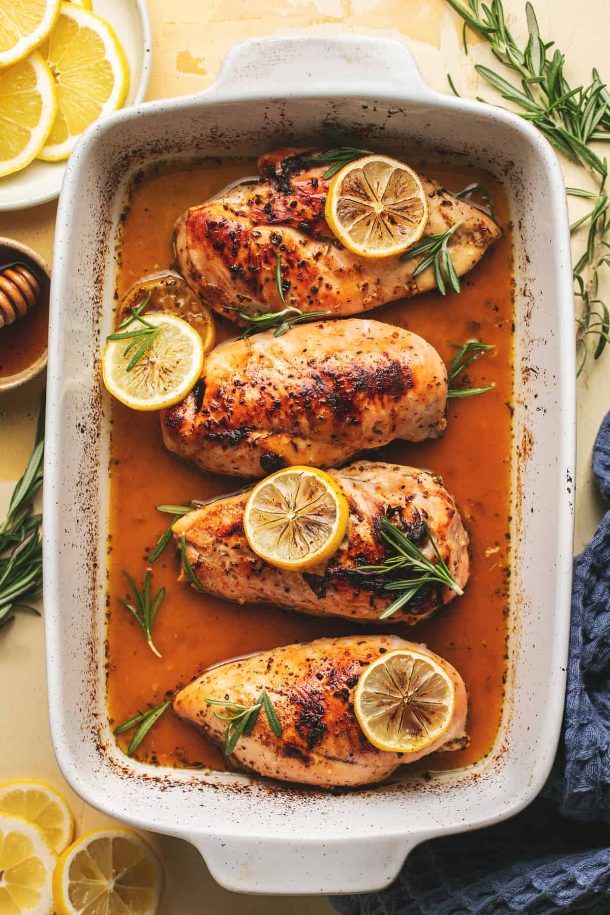 baked chicken with lemon slices in casserole dish