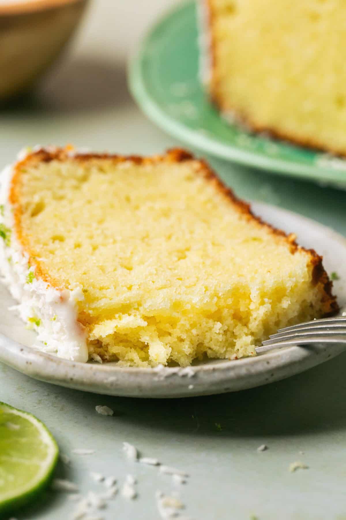 single slice of coconut lime pound cake on plate with fork