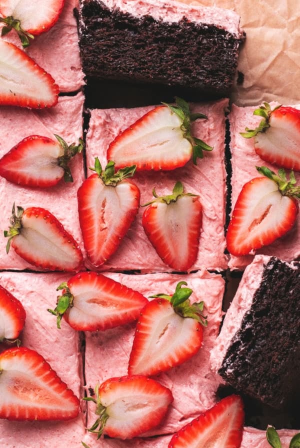 chocolate cake with strawberry frosting and fresh strawberry halves