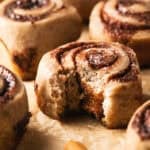 single bite taken out of cinnamon roll