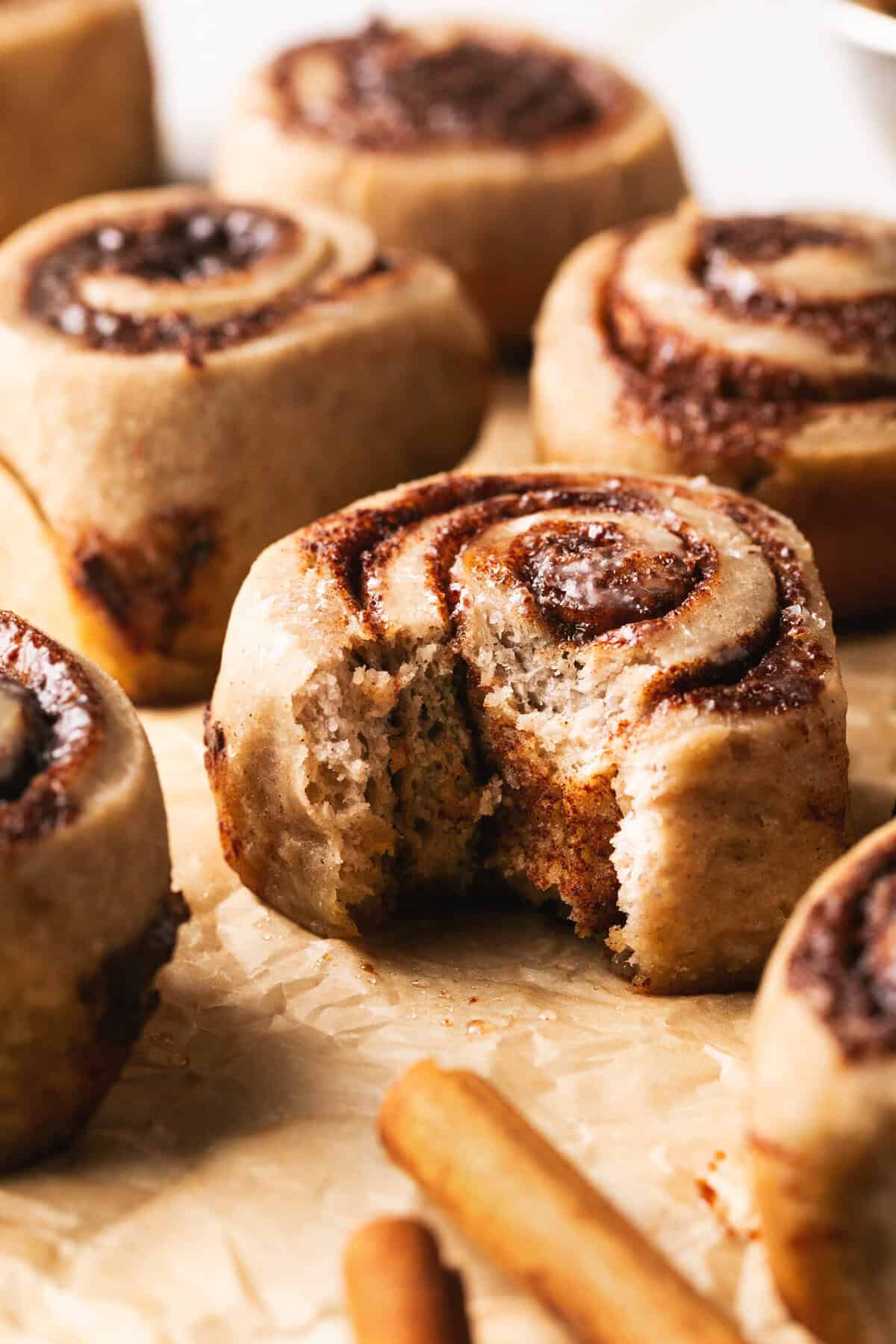 single bite taken out of cinnamon roll.