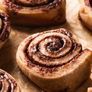 unfrosted cinnamon roll on parchment paper