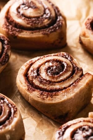 unfrosted cinnamon roll on parchment paper