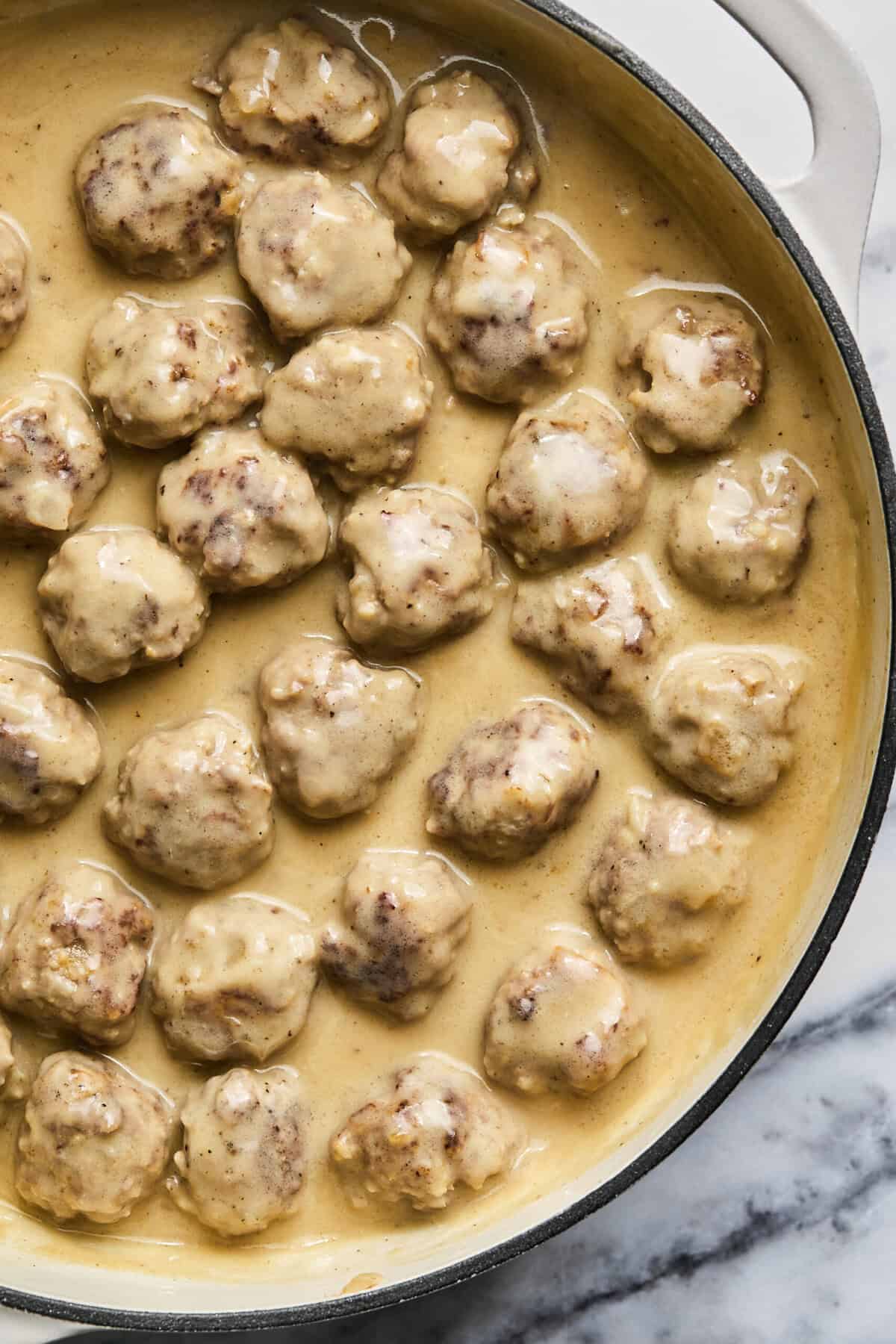 Overhead of Swedish meatballs in a skillet.
