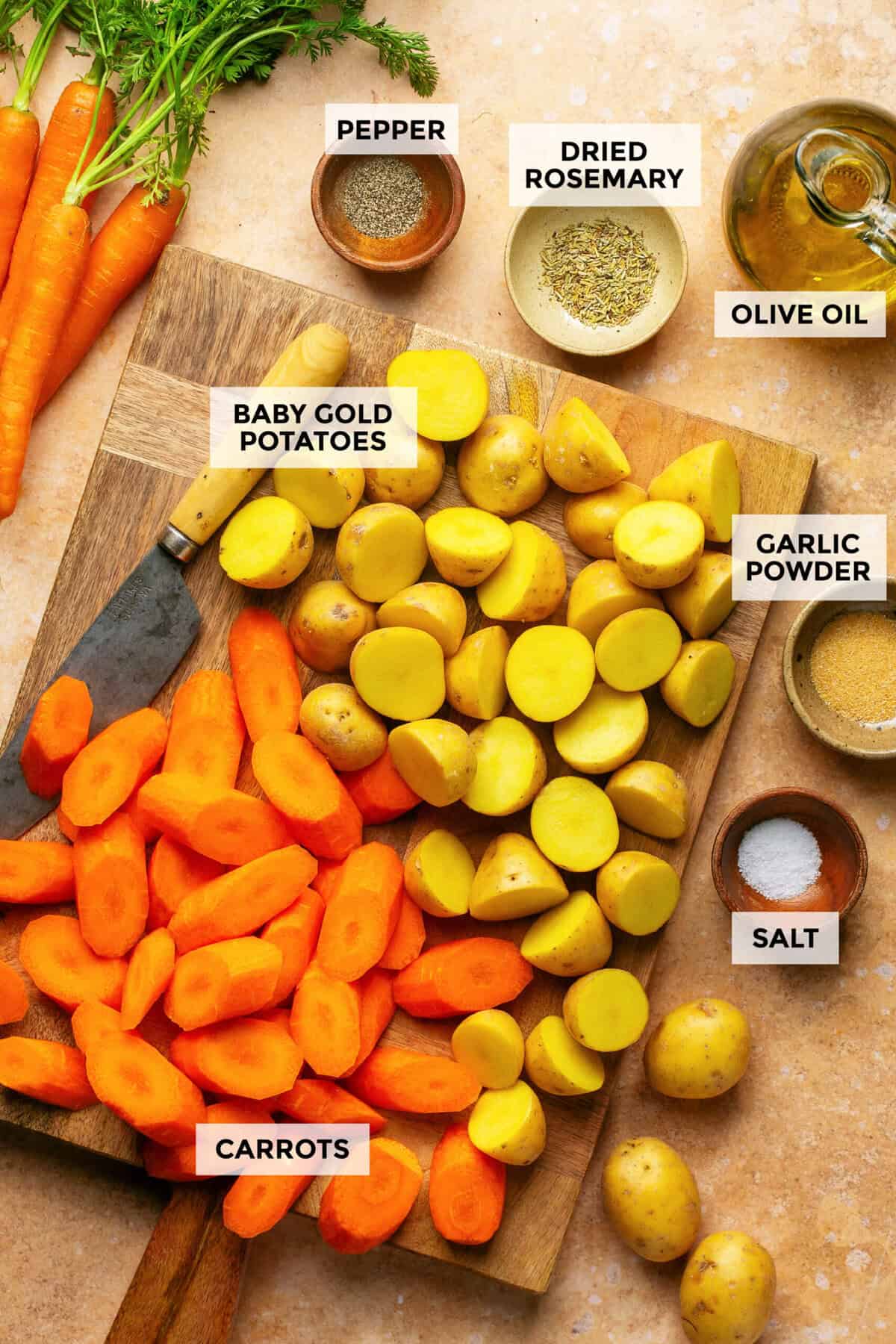 Ingredients for roasted potatoes and carrots in the oven.